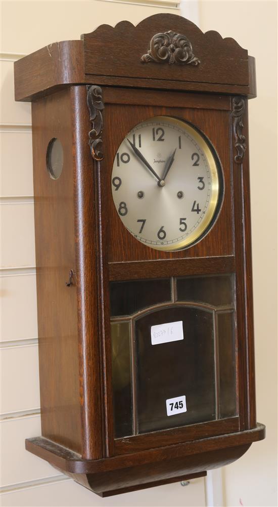 A 1930s oak wall clock, H.63cm